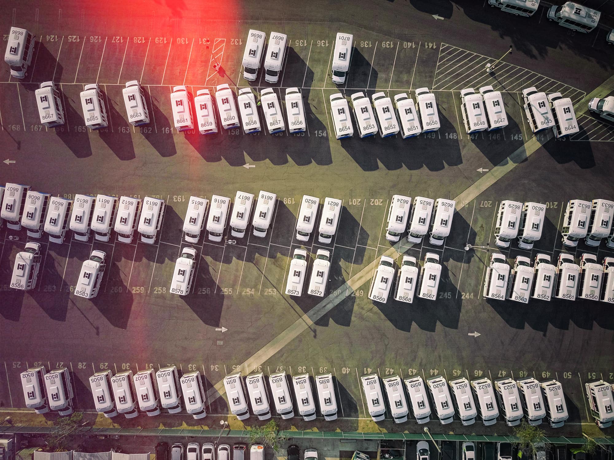 Comprehensive GPS tracking system for efficient fleet organisation Optimised van fleet management with aerial view of commercial vehicles in depot