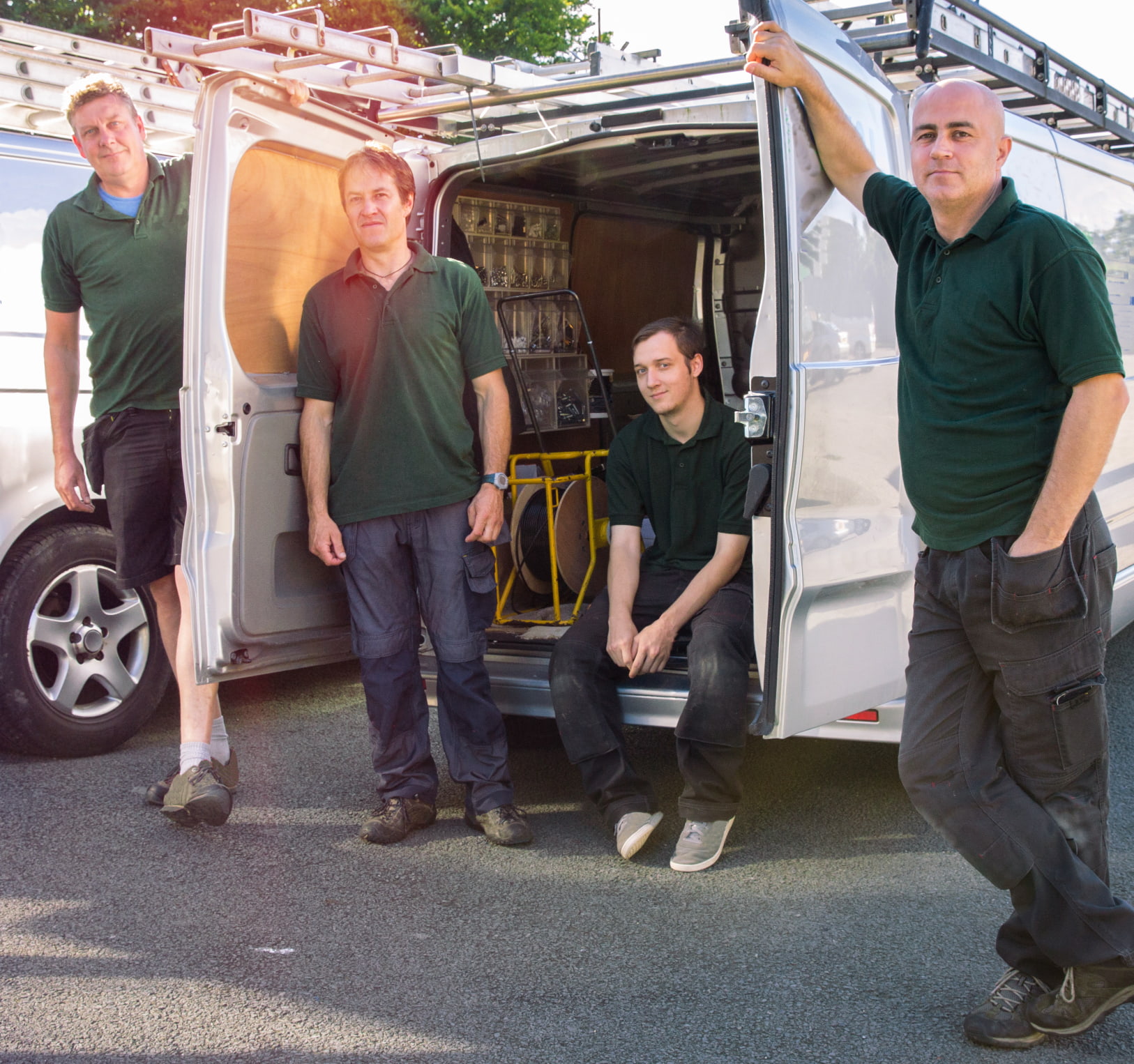 Construction van tracking solutions for improved site management and security Construction worker with safety equipment accessing van with tracker for monitoring equipment